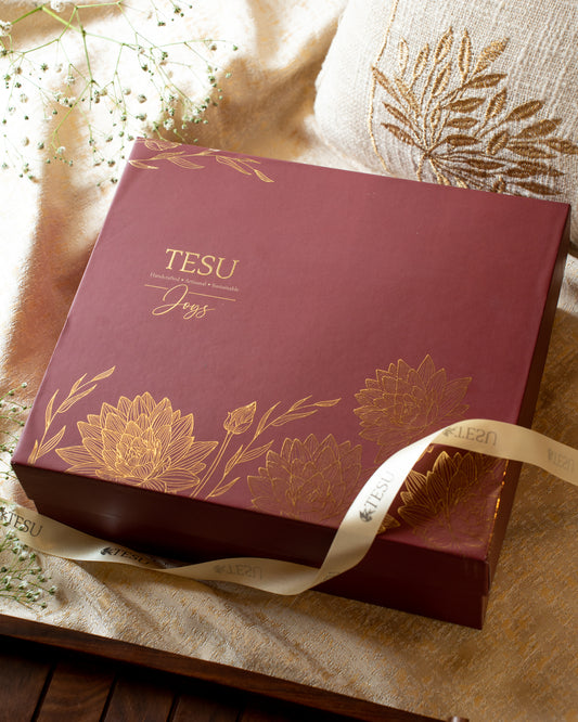 The classic deep maroon coloured&nbsp; boxes engraved with auspicious golden lotus flowers makes it elegant at the same time festive. Its a delightful collection of India inspired socially conscious products , designed to last and influenced by the culture and traditions we grew up in and definitely made to bring Joys.