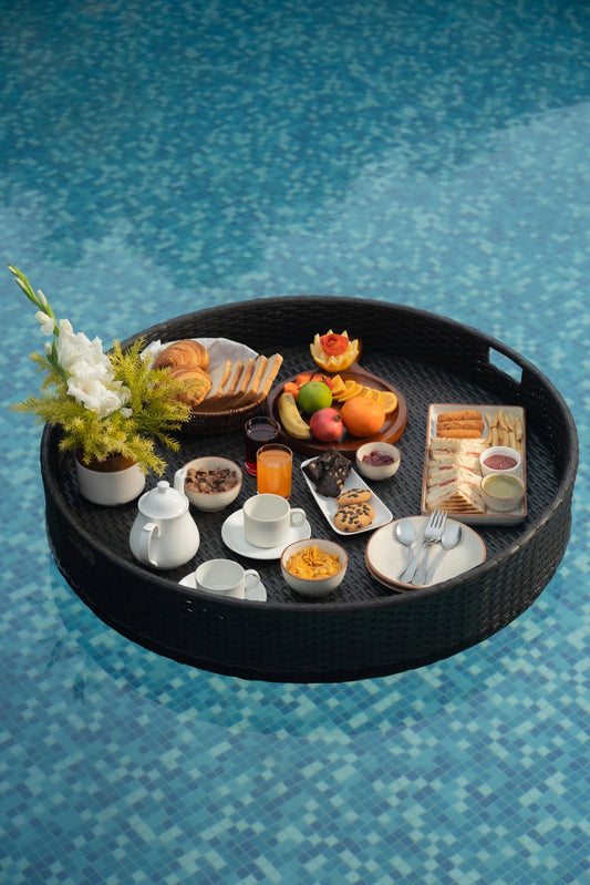 Floating trays Poolside luxury Pool party essentials Versatile pool floats Rattan style design Handcrafted in Bali Synthetic fibers Environmentally friendly Non-toxic materials Multiple uses Hot tub accessory Summer pool party Portable serving tray Resort amenities Unique guest experiences Luxury pool accessories Innovative hotel amenity tesu 