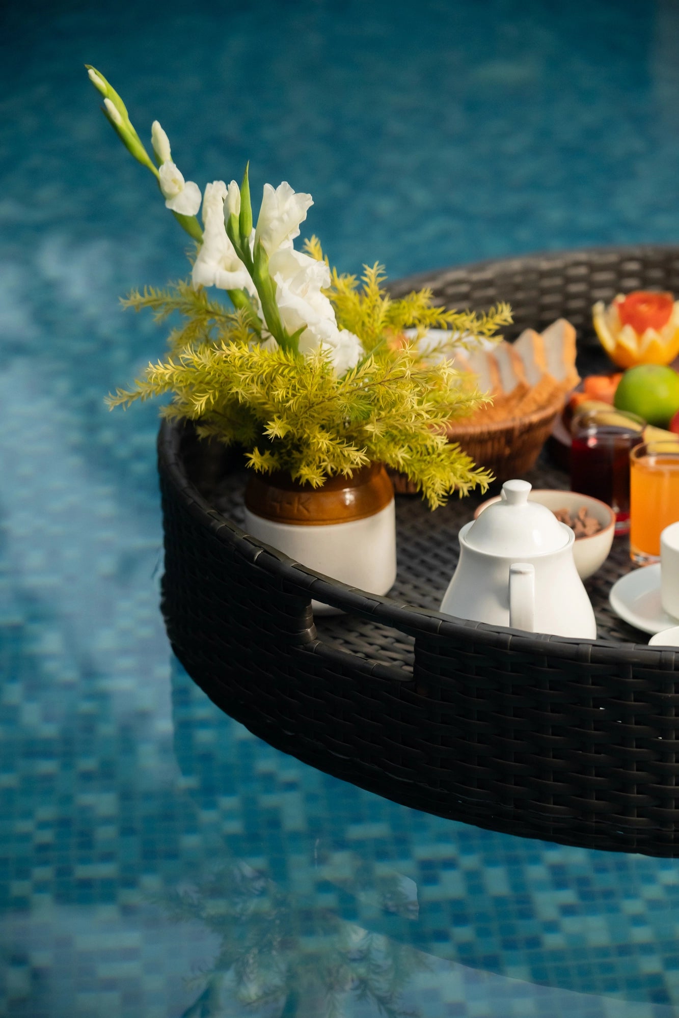 Floating trays Poolside luxury Pool party essentials Versatile pool floats Rattan style design Handcrafted in Bali Synthetic fibers Environmentally friendly Non-toxic materials Multiple uses Hot tub accessory Summer pool party Portable serving tray Resort amenities Unique guest experiences Luxury pool accessories Innovative hotel amenity tesu