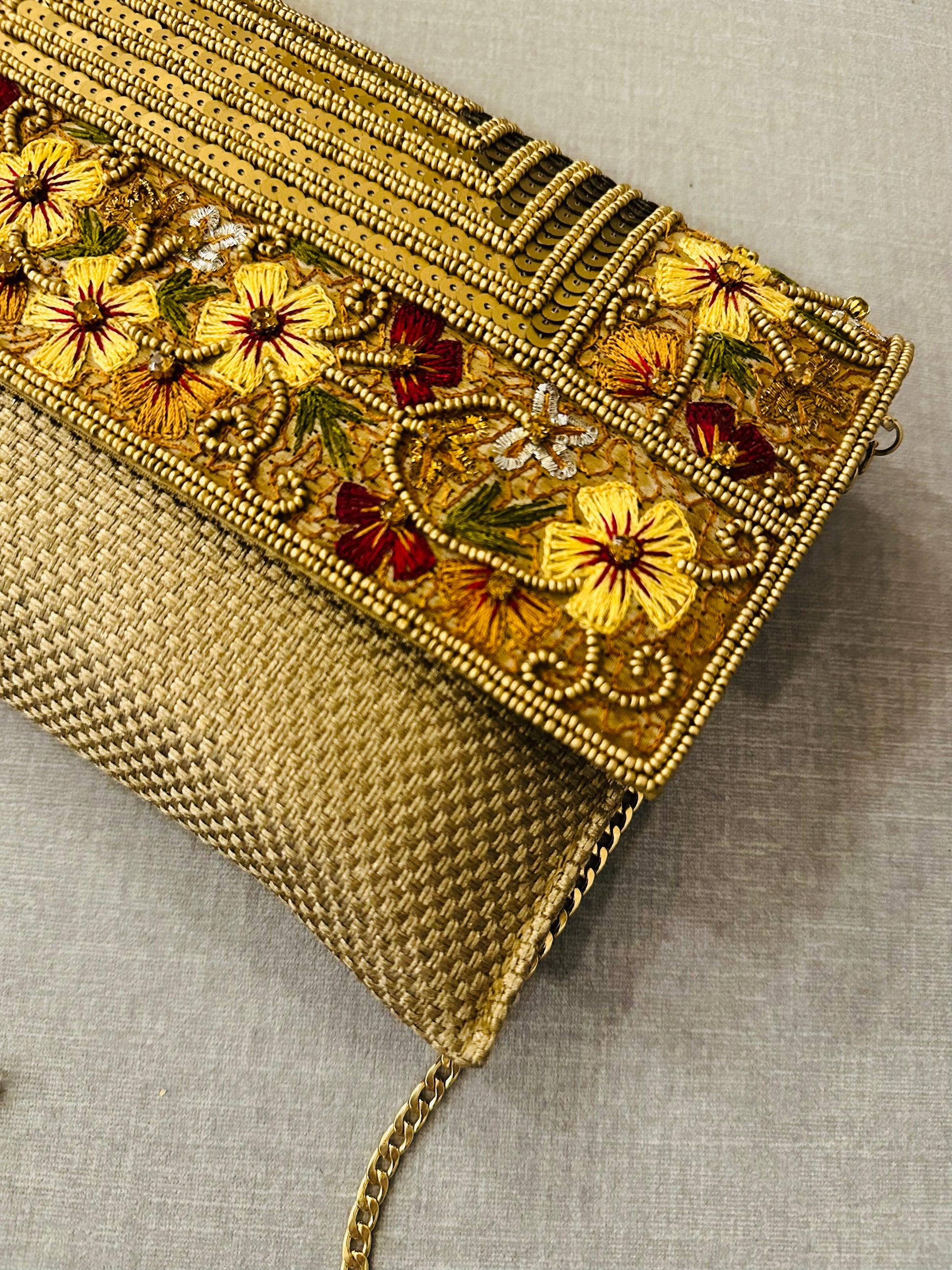 Zardozi clutch with detachable metal chain showing versatile sling and clutch functionality