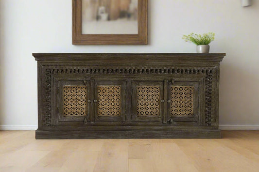Dark wooden cabinet with intricate carvings on a white background