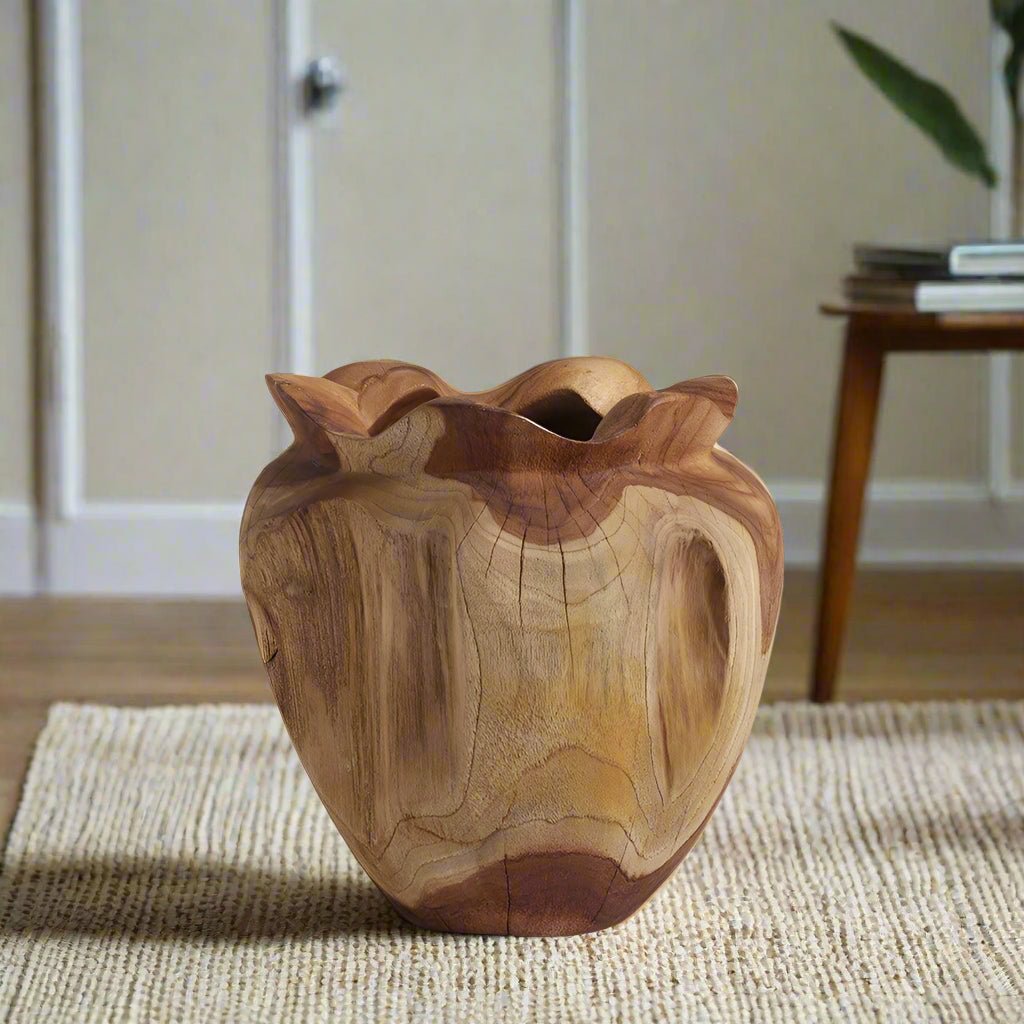 Crafted from a single block of richly grained teak wood, the Rooted Heart Vase celebrates the raw beauty of nature with sculptural form and soulful texture.