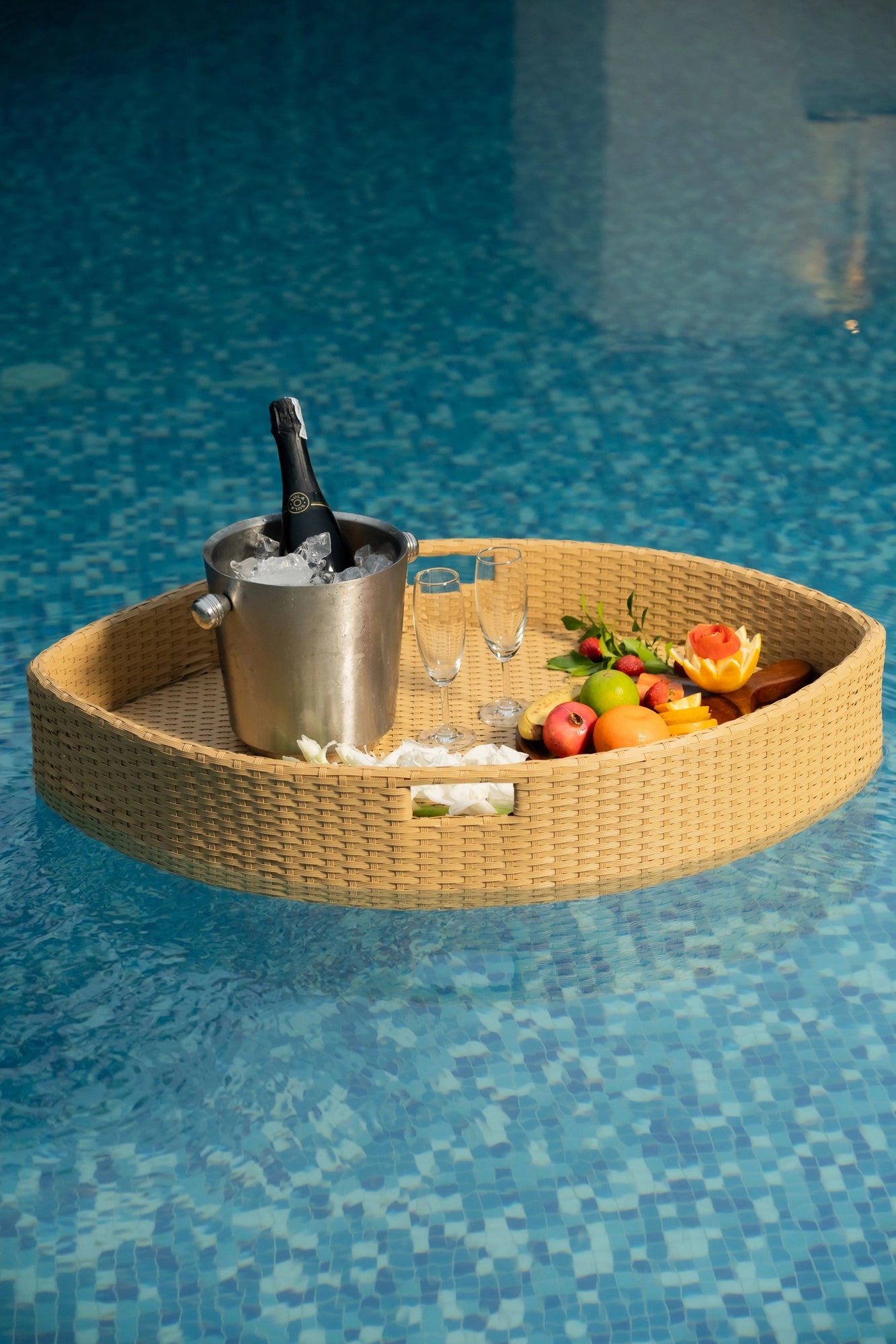 Floating breakfast tray Poolside luxury Pool party essentials Versatile pool floats Rattan style design Handcrafted in Bali Synthetic fibers Environmentally friendly Non-toxic materials Multiple uses Hot tub accessory Summer pool party Portable serving tray Resort amenities Unique guest experiences Luxury pool accessories Innovative hotel amenity tesu 