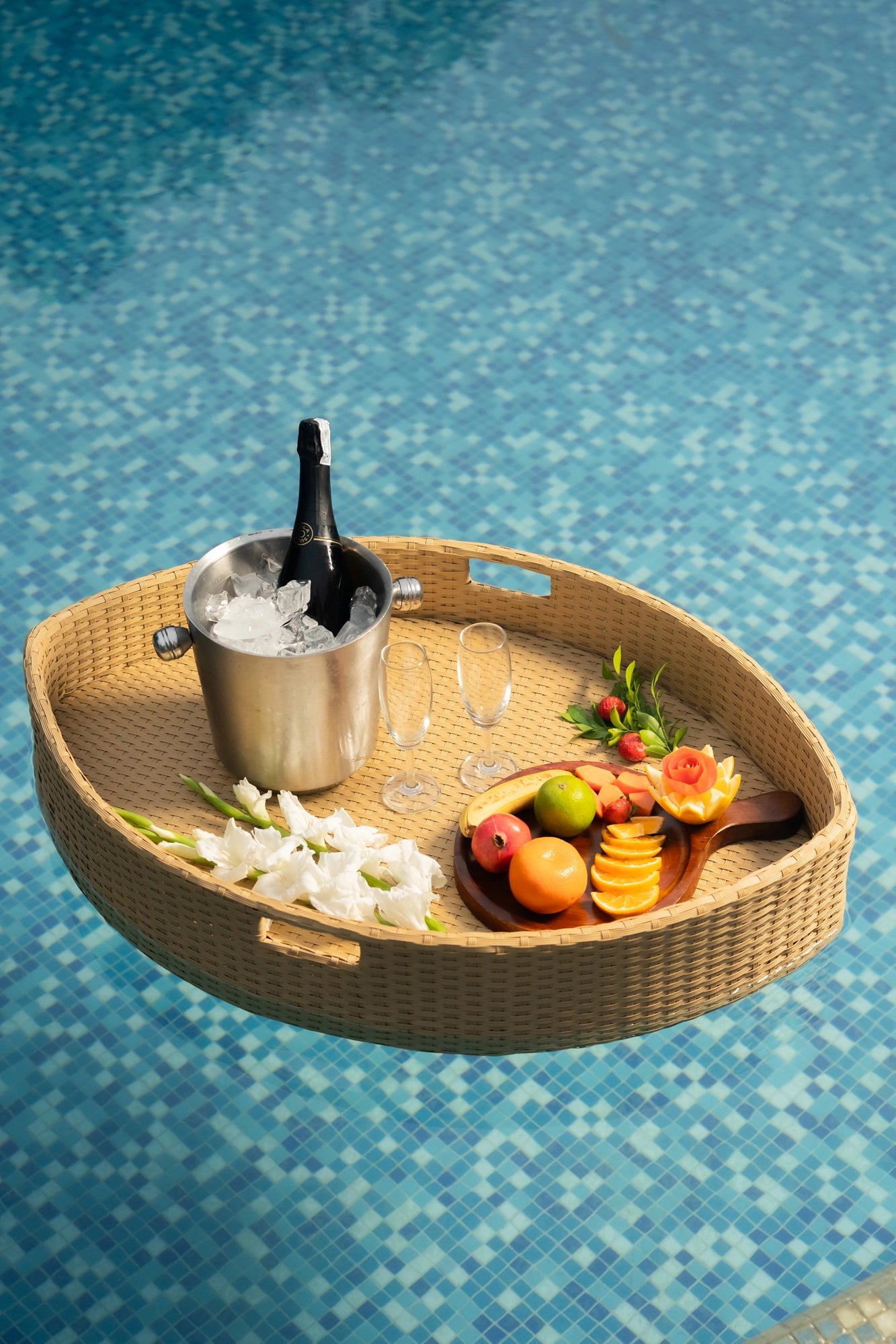 Floating breakfast tray Poolside luxury Pool party essentials Versatile pool floats Rattan style design Handcrafted in Bali Synthetic fibers Environmentally friendly Non-toxic materials Multiple uses Hot tub accessory Summer pool party Portable serving tray Resort amenities Unique guest experiences Luxury pool accessories Innovative hotel amenity tesu 