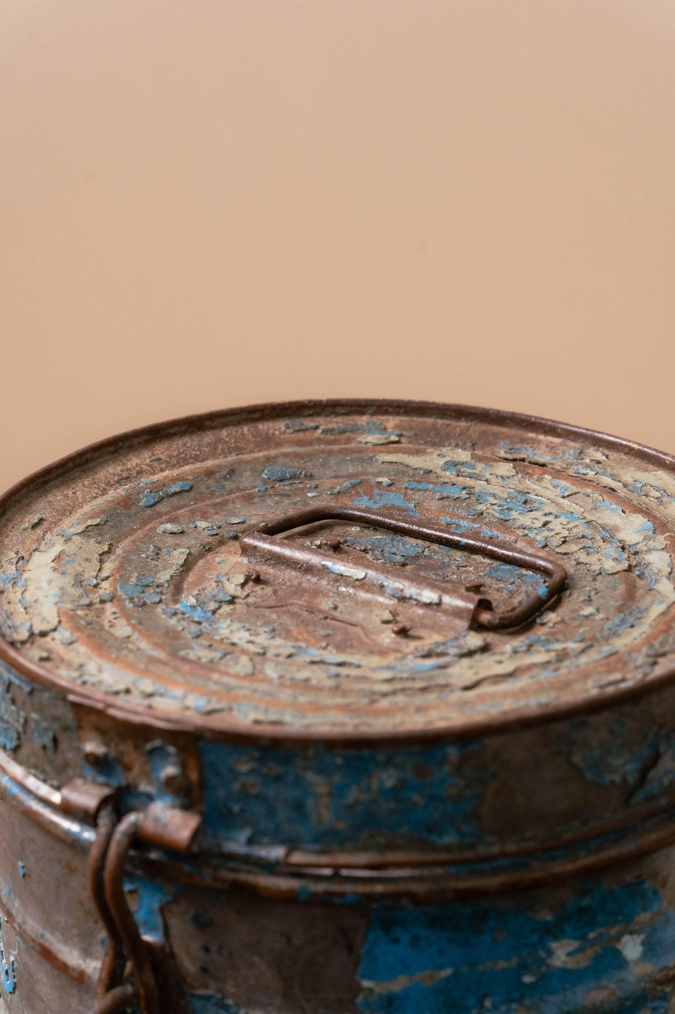 Vintage blue iron canister displaying weathered finish perfect for farmhouse and coastal home decor