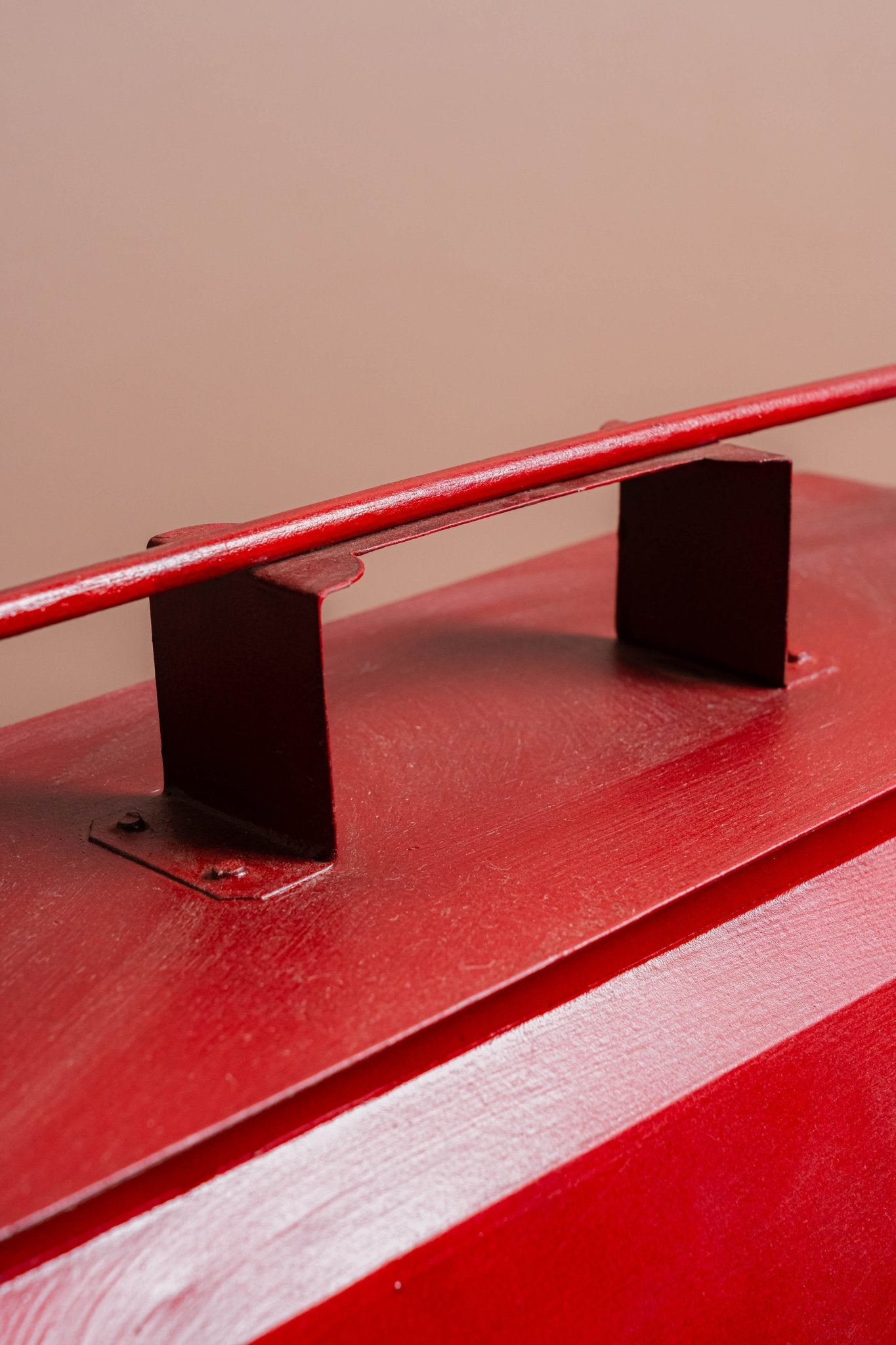 Red Coca-Cola cooler on a wooden surface with a beige background
