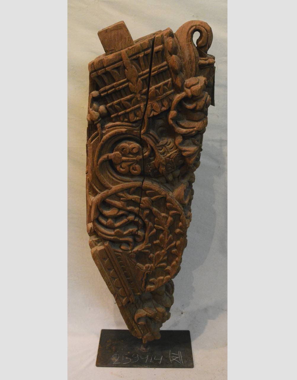 Decorative wooden panel with intricate carvings on a white background
