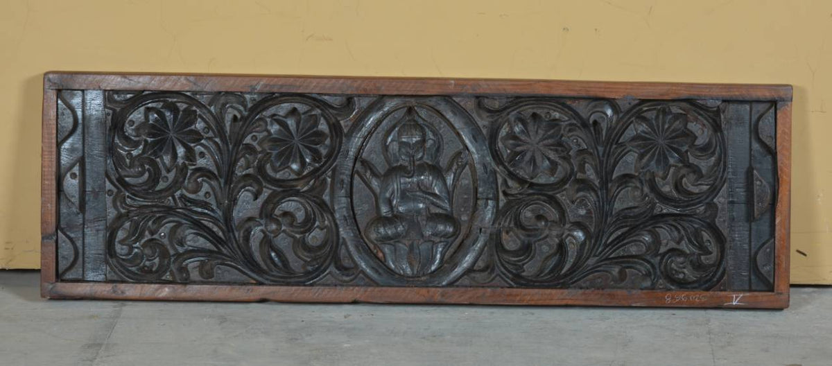 Close-up of carved Ganesha motif on wooden panel – Tesu