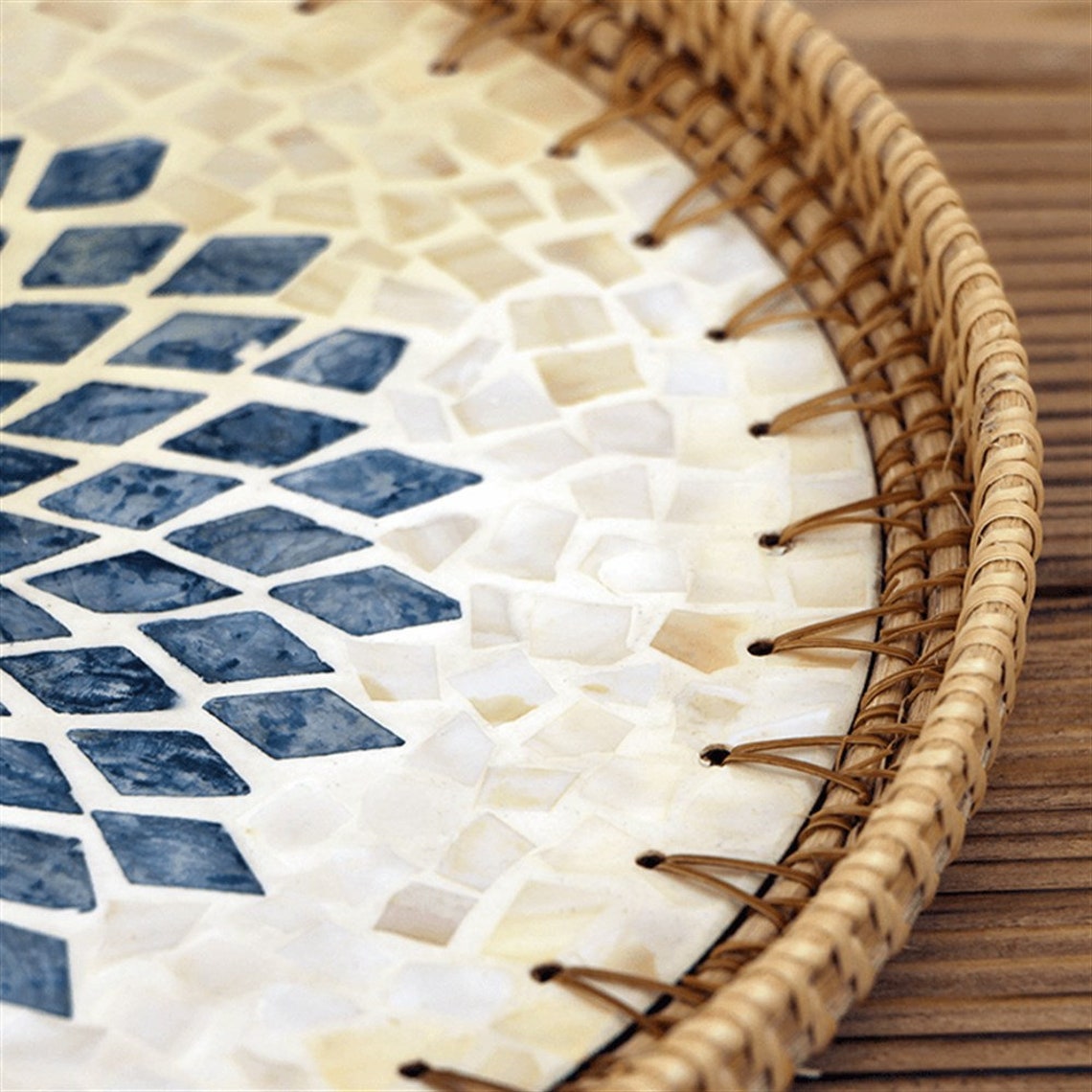 Round Mother Of Pearl Rattan Tray is made with handwoven rattan material mixed mother of pearl is durable and eco-friendly, add a natural touch to any room. Impress your guests with these beautiful hand woven serving trays made with natural Rattan. In effortlessly chic hand-woven round tray has a designer motifs on it which make it a center of attraction . It can also be beautifully used as a display piece on your coffee table as a wall decor. TESU