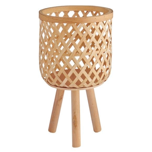 bamboo light planter tesu with folding legs boho home style setup.Enhance your Dream Home with our curated selection of premium Home Décor items.  Typically crafted Bamboo woven planter with removable wooden legs are creating an eco -friendly and aesthetically pleasing container for plants. Its intricate handwoven design adds a touch of rustic charm to any to indoors as well as covered outdoor spaces like the living room, balcony, patio or a roofed terrace. tesu