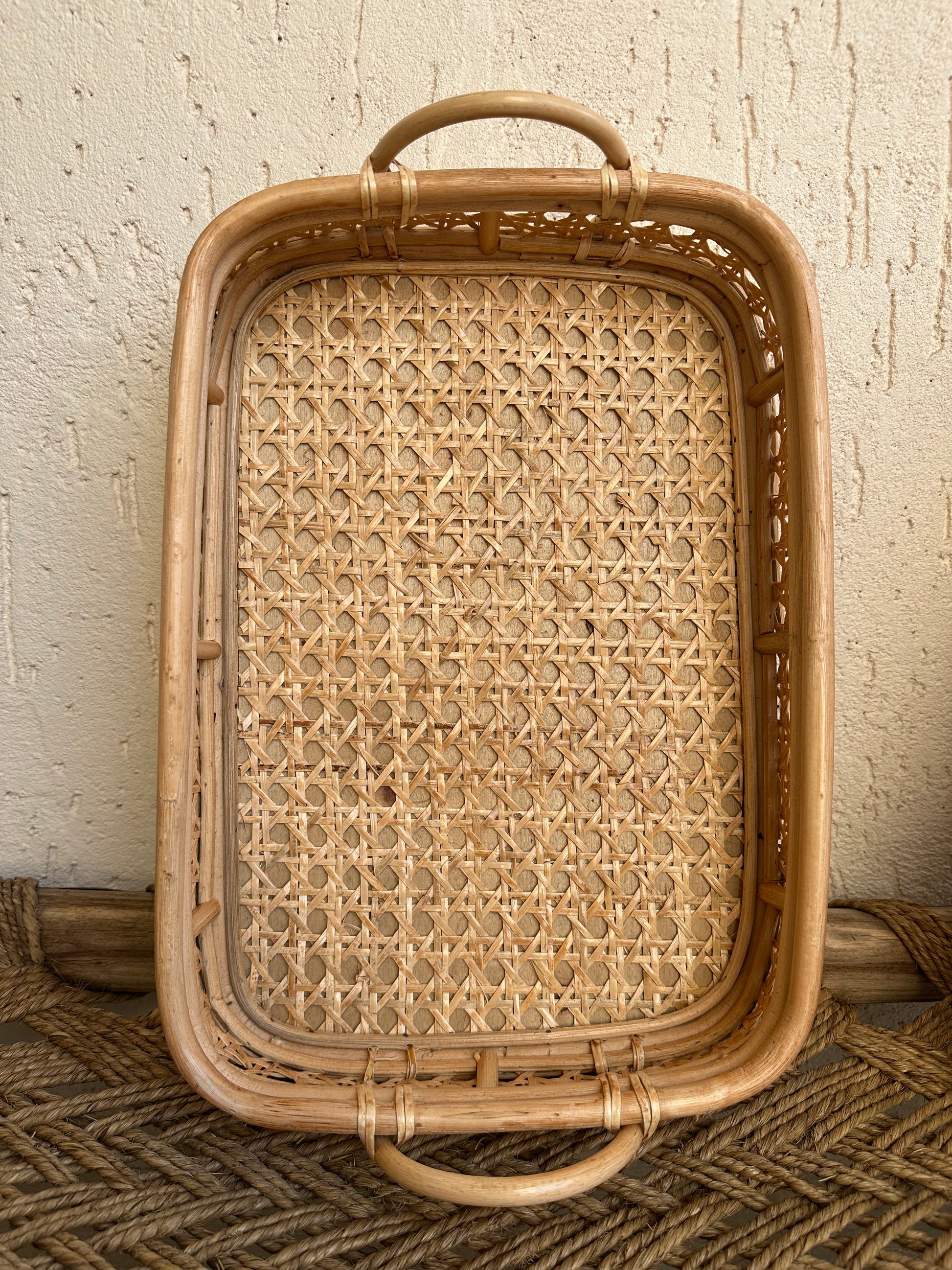 This lovely rattan tray is a must have to create stylish spaces. In effortlessly chic hand-woven cane with detailed wicker pattern makes it an eye catcher. This multipurpose tray look gorgeous on a coffee table with plants and candles , storage for blankets in living room or place them in bathroom with rolled up towels to merge functionality with stylish charm. TESU