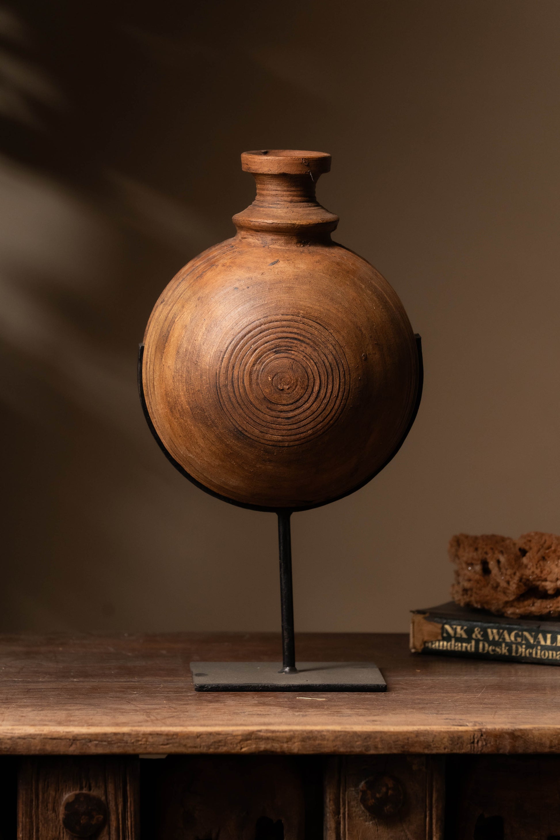 Step into a world where tradition meets sophistication with Tesu home decor Antique Black Clay Pot with Iron Stand.