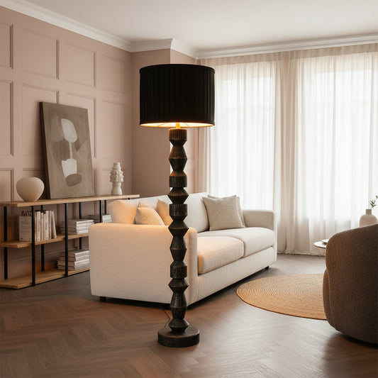 Decorative floor lamp with a black shade in a room setting.