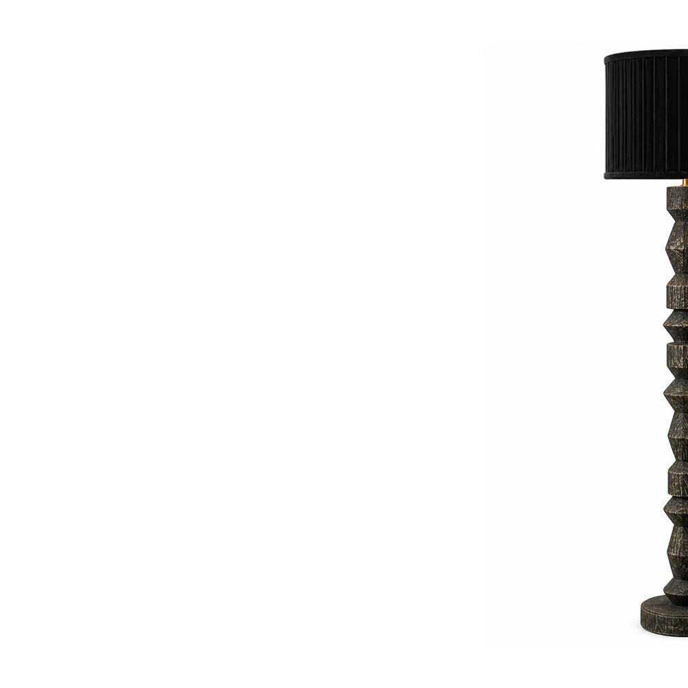 Floor lamp with a textured base and black shade on a white background