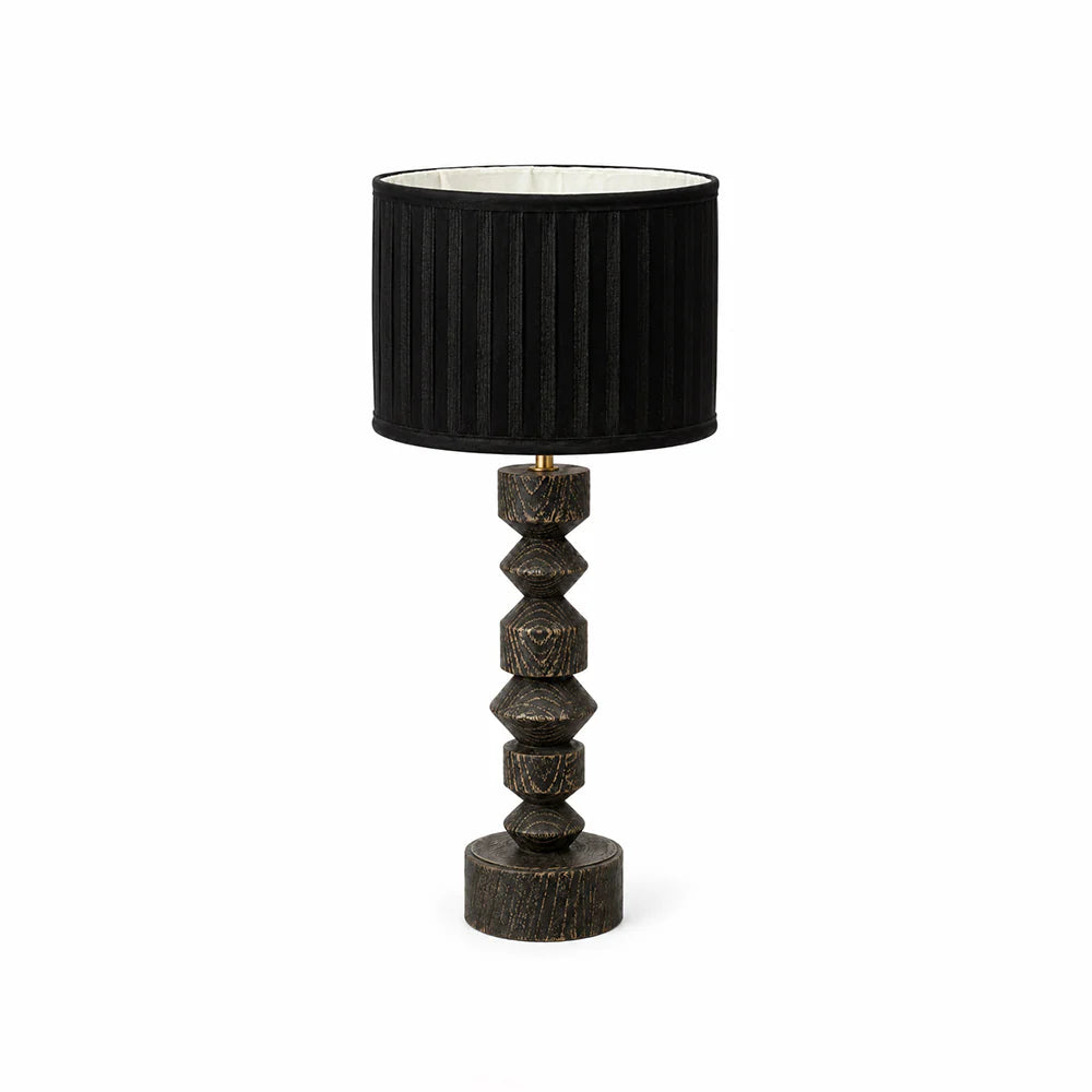 Table lamp with black shade and textured wooden base on a white background