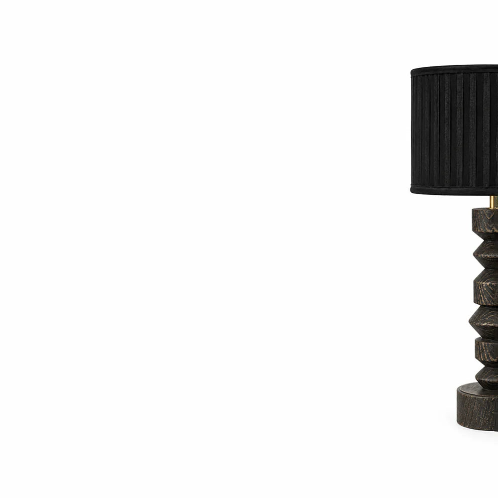Black table lamp with geometric base on a white background