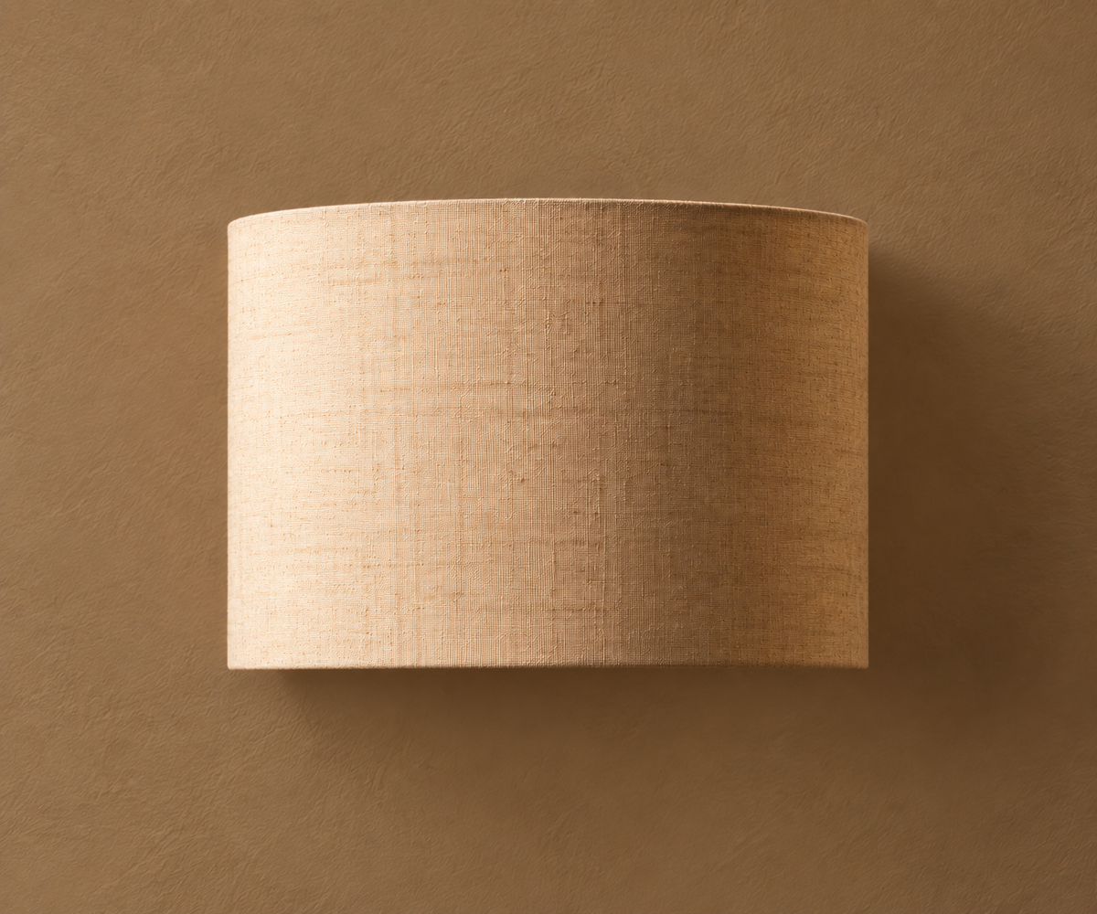 A cylindrical drum lampshade made of textured beige linen fabric, shown against a matching textured brown background.