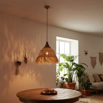 Decorative pendant light casting shadows on a wall with warm lighting.