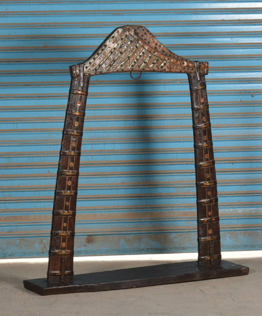 Handcrafted from solid teak wood, reinforced with iron accents, and adorned with intricate brass detailing, this unique display piece is designed to bring a regal touch to any space