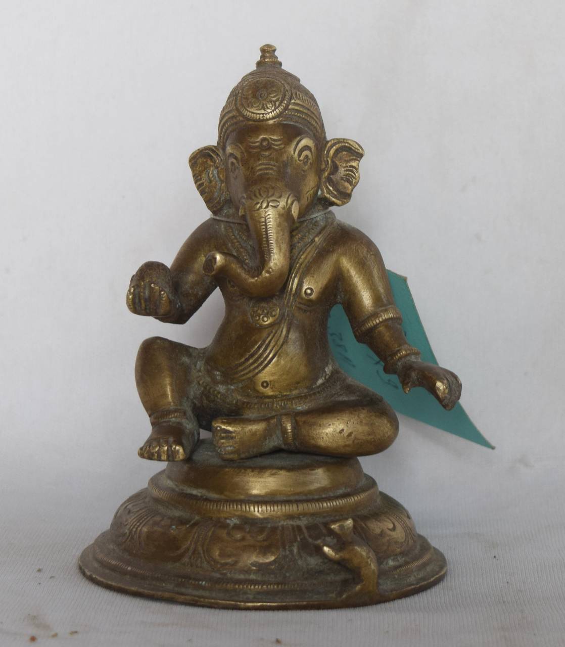  The intricate detailing on the crown, ears, and base reflects traditional Indian craftsmanship, while the antique brass finish adds timeless elegance to any setting.