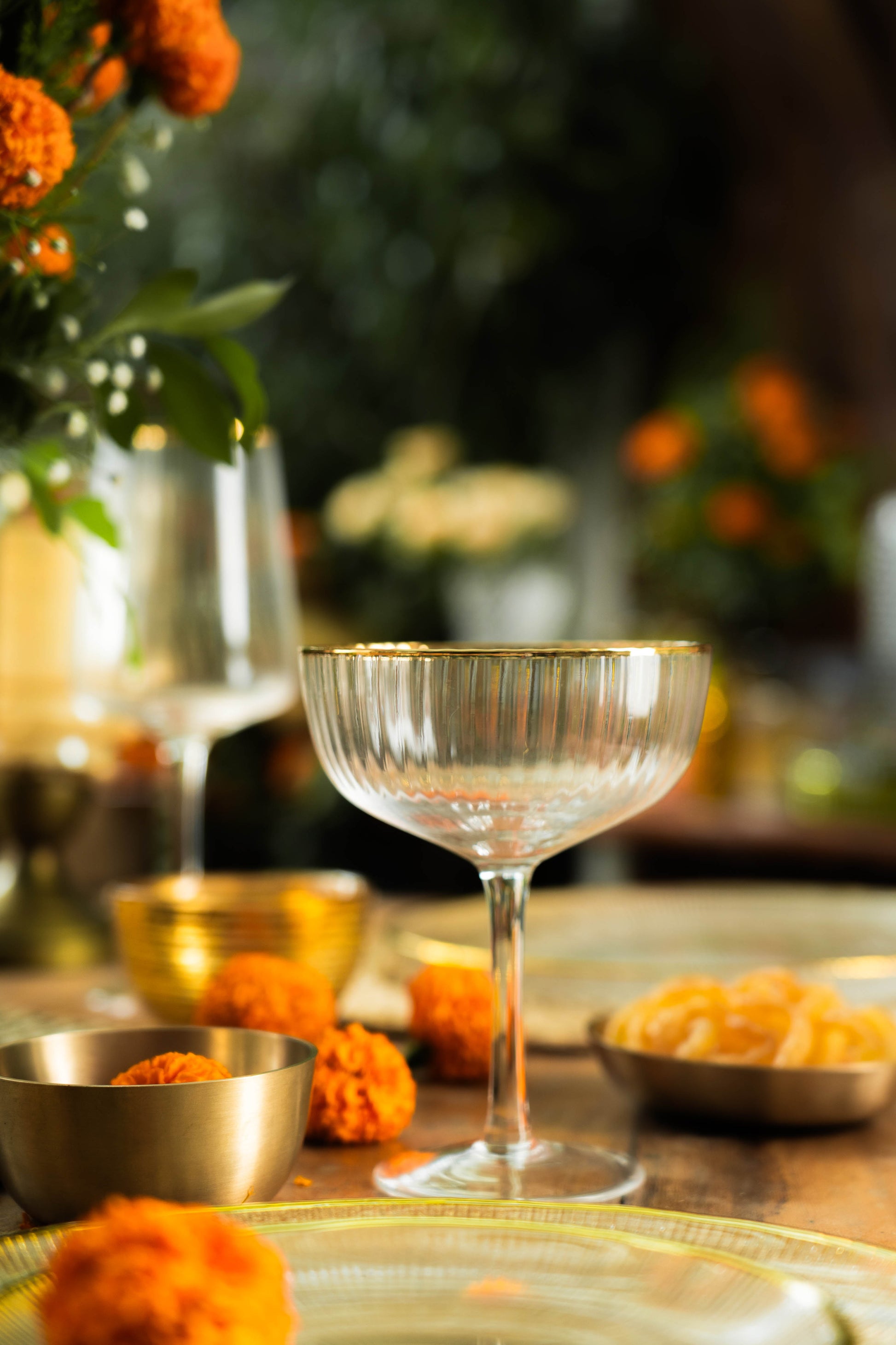 Cocktail glass on a table with decorative elements and blurred background