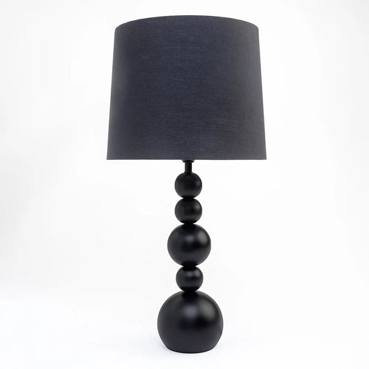  Featuring a stacked orb base crafted in sleek metal, its silhouette captures a sense of balance and modern sophistication. 