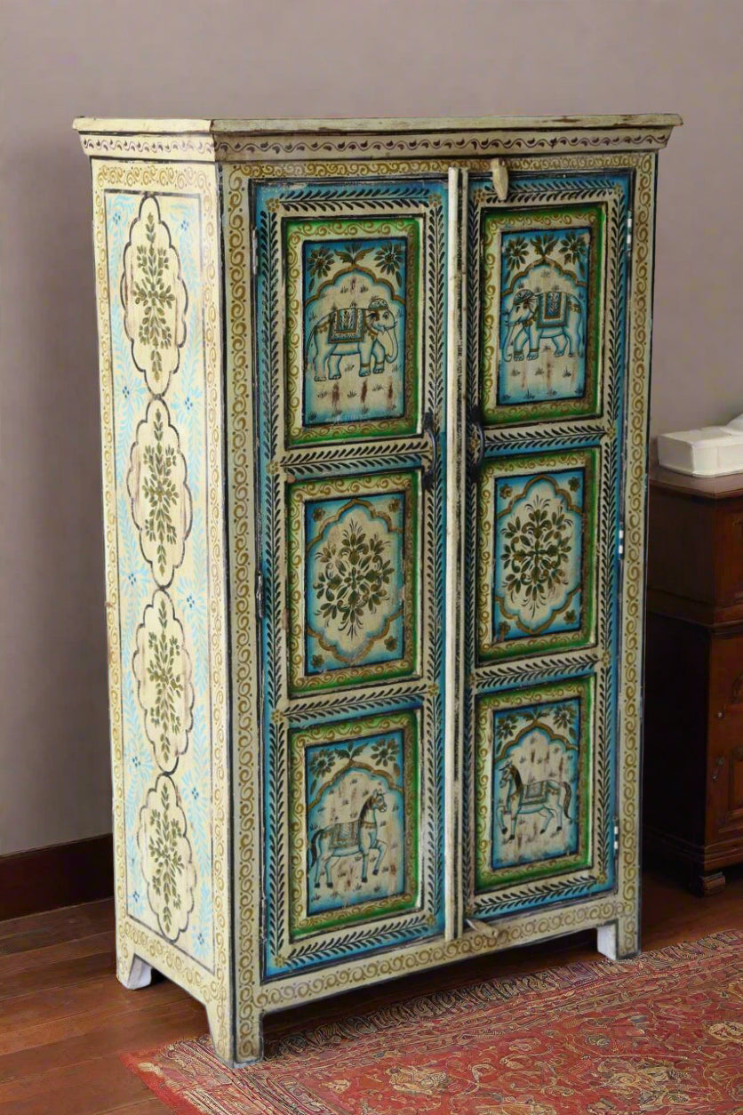 Decorative wooden cabinet with intricate carvings against a white brick wall.