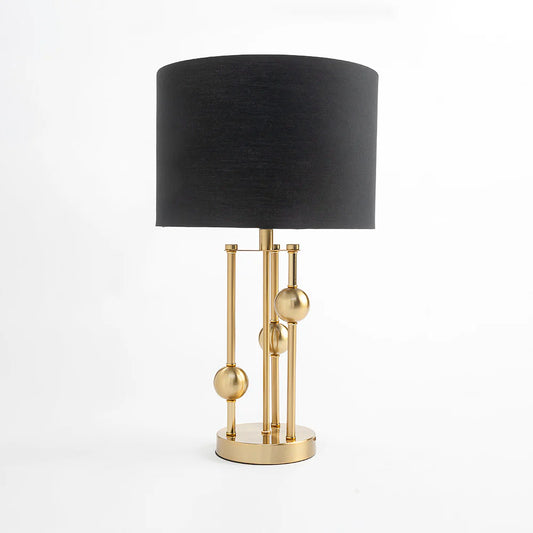  Featuring a polished metal base with graceful curves and a soft fabric shade, this lamp blends modern sophistication with timeless charm. 