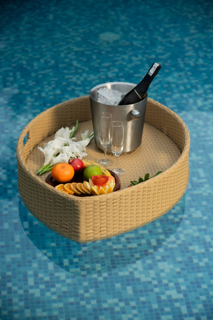 Floating breakfast tray Poolside luxury Pool party essentials Versatile pool floats Rattan style design Handcrafted in Bali Synthetic fibers Environmentally friendly Non-toxic materials Multiple uses Hot tub accessory Summer pool party Portable serving tray Resort amenities Unique guest experiences Luxury pool accessories Innovative hotel amenity tesu 