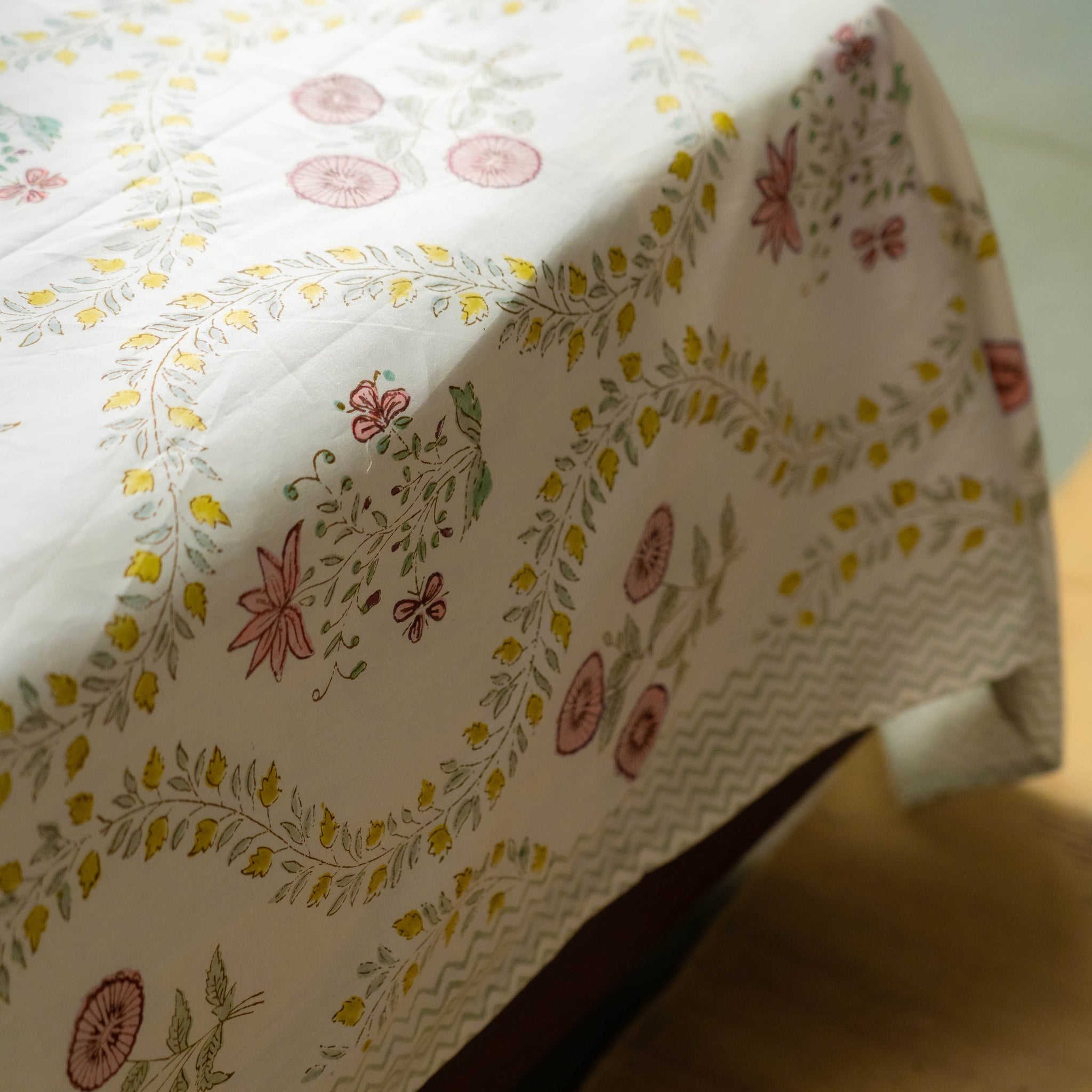 Floral patterned tablecloth on a wooden surface