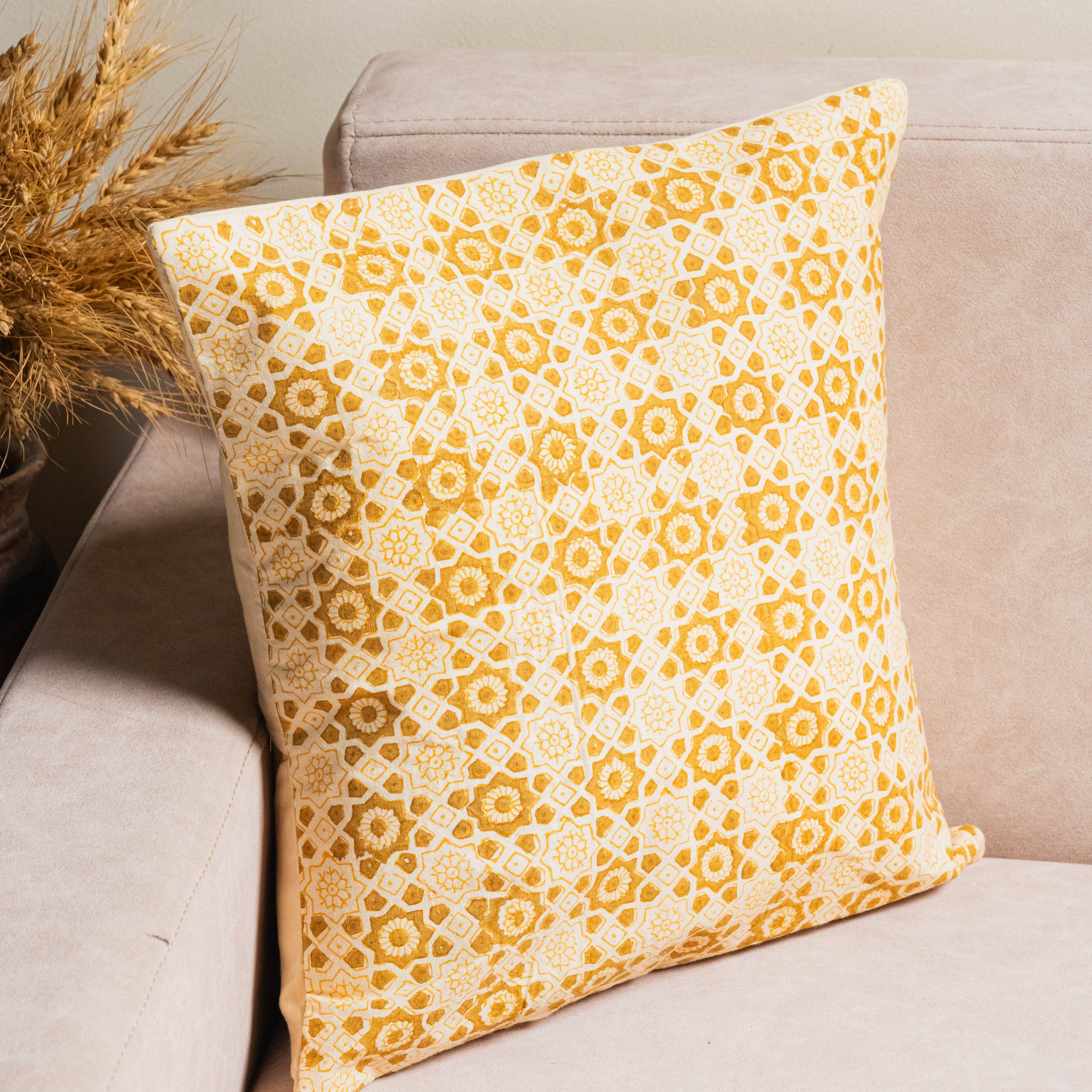 The Gehuva Rang Baagh Cushion Cover celebrates the timeless charm of beige hues with traditional hand block printing.