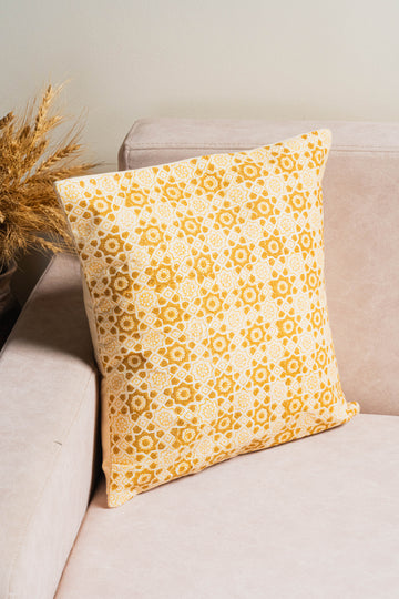 The Gehuva Rang Baagh Cushion Cover celebrates the timeless charm of beige hues with traditional hand block printing.