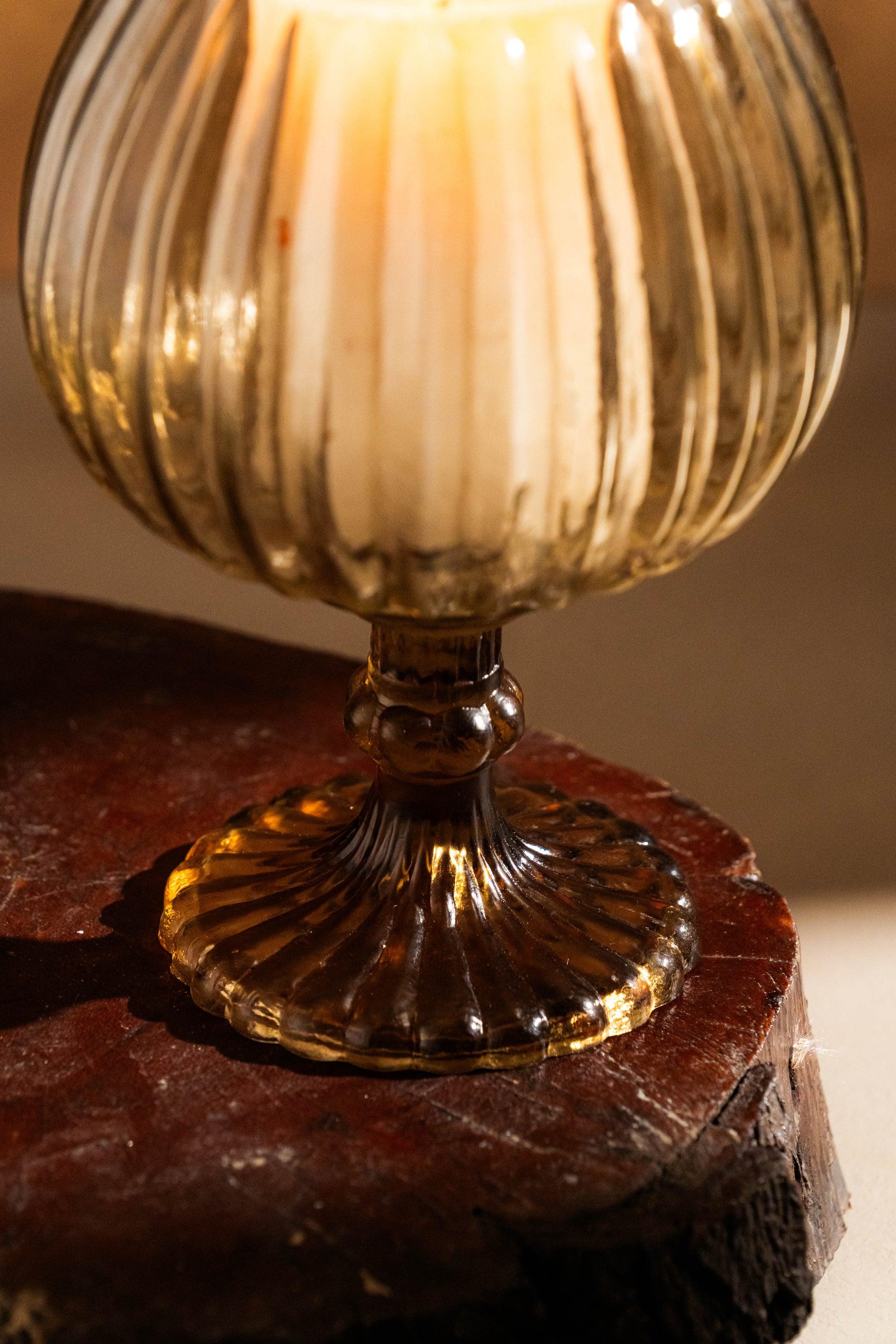 Decorative glass goblet on a stone surface with warm lighting