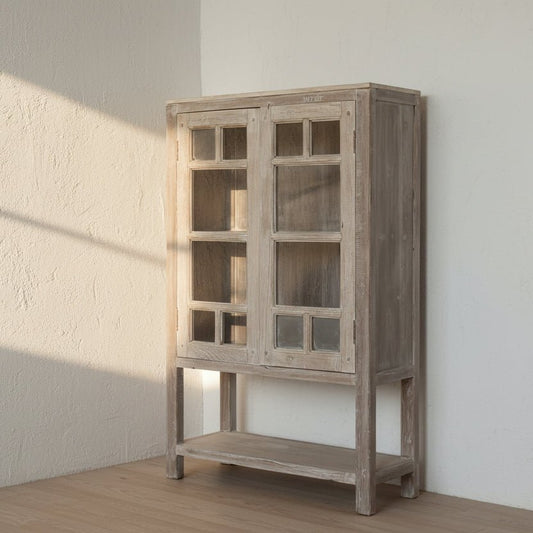 Wooden cabinet with glass doors in a minimalistic room