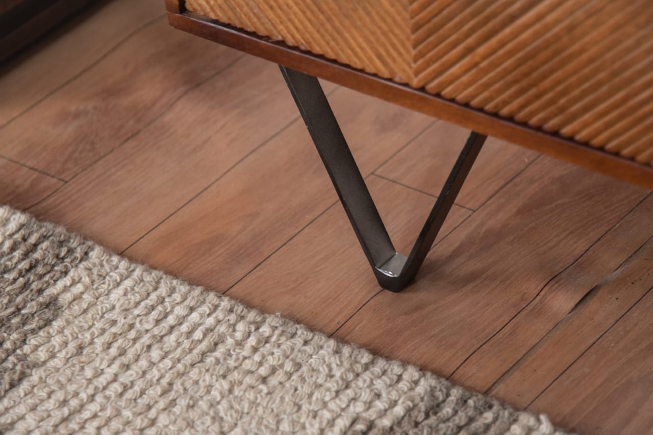 The sturdy yet sleek black iron legs elevate the design, creating a perfect balance between contemporary and vintage aesthetics.