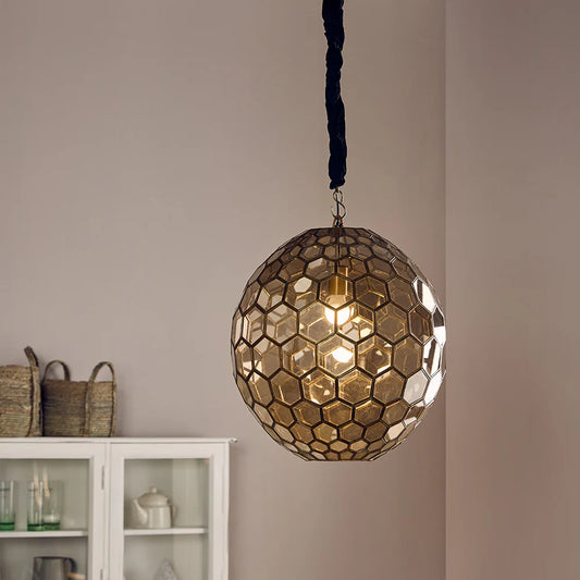 Illuminate your space with the warm, inviting charm of the Golden Hive Pendant.