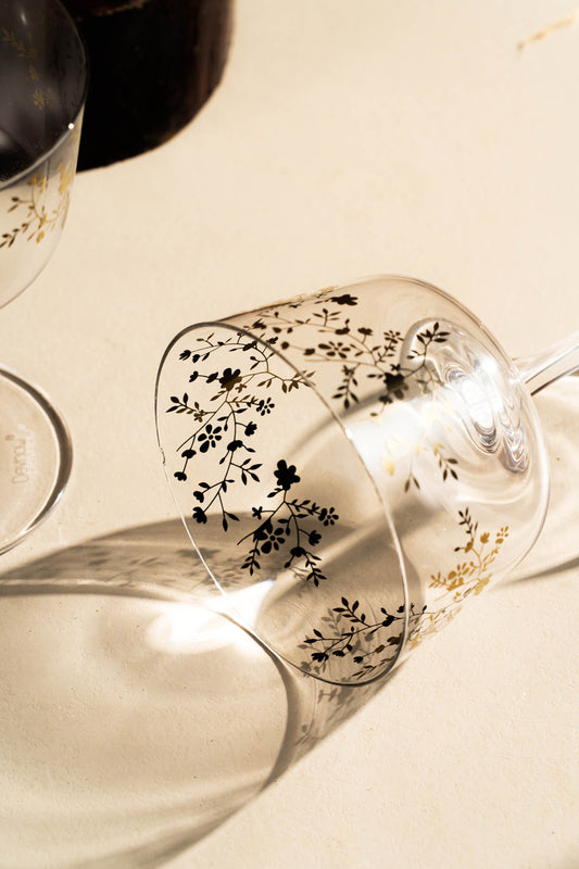 Decorative glassware with floral patterns on a neutral background