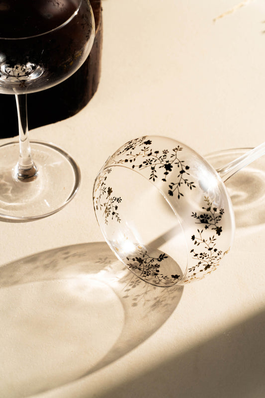 Wine glass with floral design on a marble surface