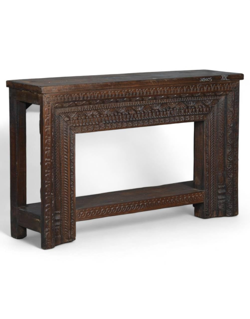 Side view of hand-carved wooden table showing carved leg and apron detail – Tesu Furniture & Seating