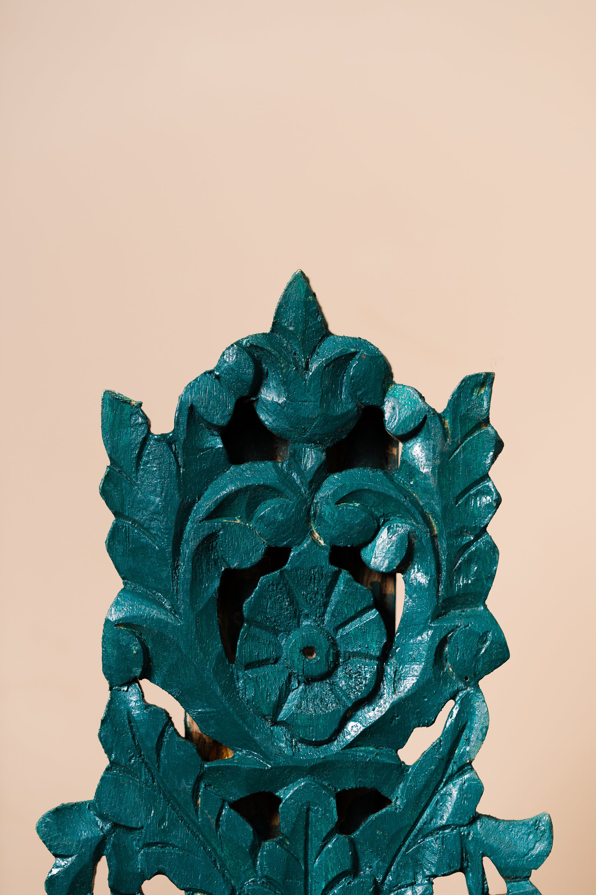 Hand-carved wooden stand, Green wooden stand, Functional art stand, Plant holder stand, Decorative object stand, Brass artefact display, Skilled artisan stand, Rustic wooden stand, Ornate wooden stand, Natural motif carving, Geometric pattern stand, Cultural symbol décor, Green finish stand, Wall-mounted stand, Tabletop display stand, tesu 