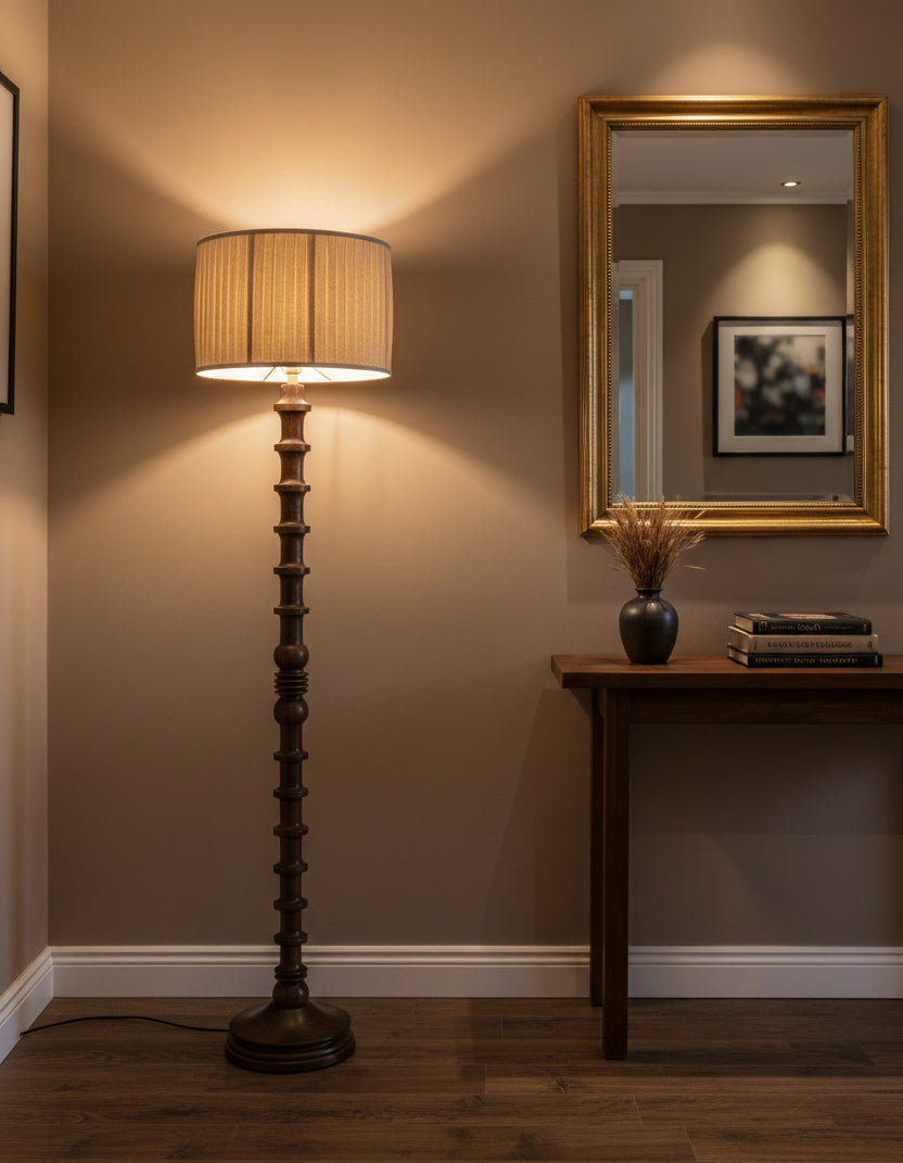 Wooden floor lamp with a beige lampshade on a white background