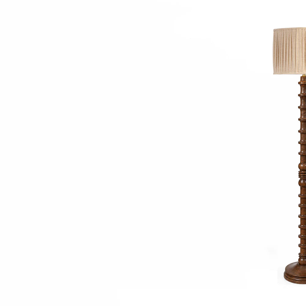 Wooden floor lamp with a beige lampshade on a white background