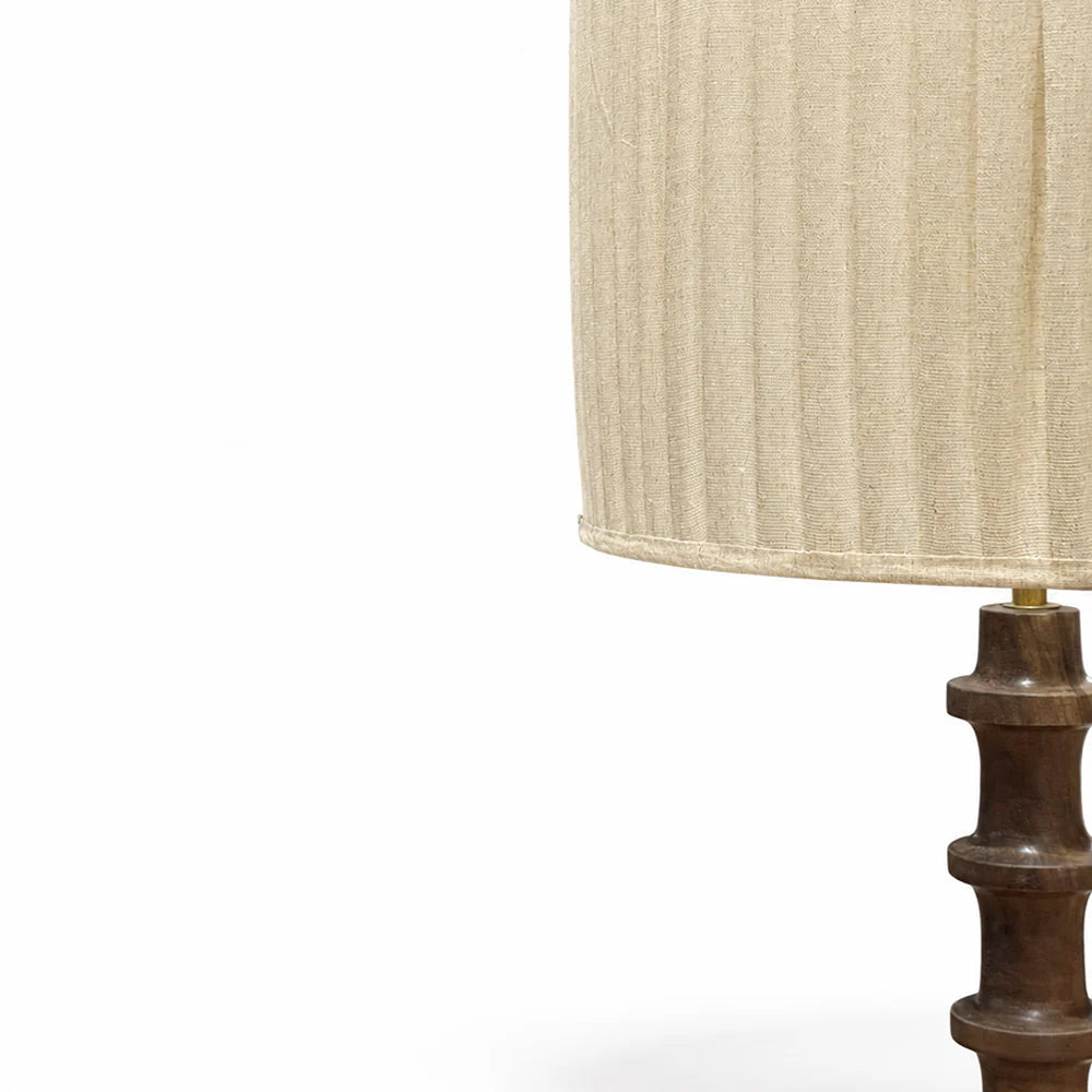 Lamp with a beige shade and wooden base on a white background