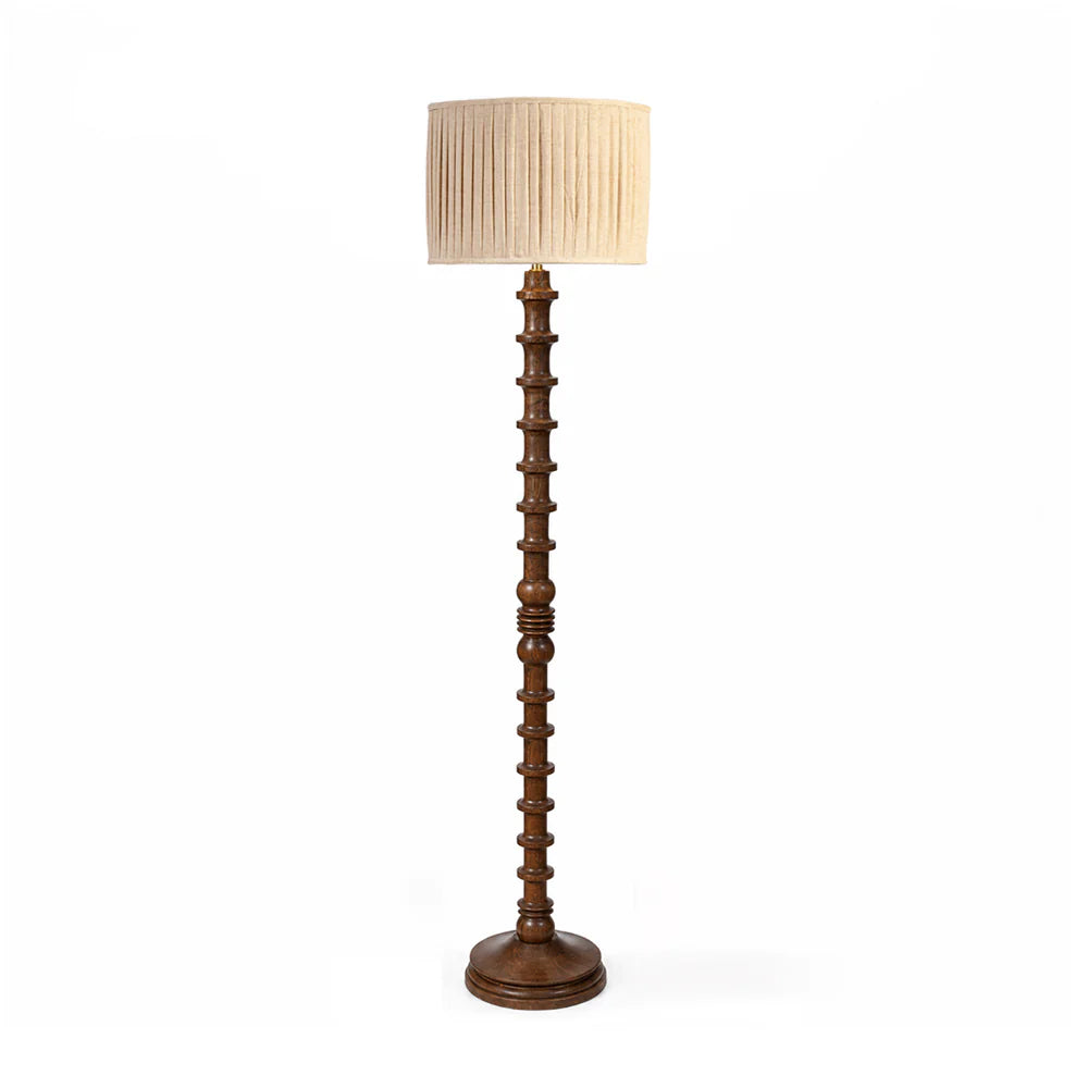 Wooden floor lamp with a beige lampshade on a white background