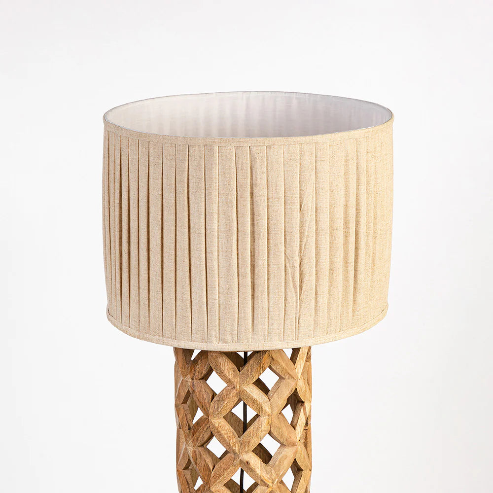Lamp with woven base and beige lampshade on a white background