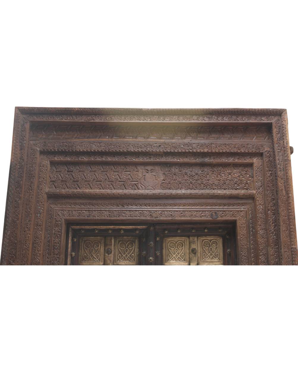Decorative wooden panel with intricate carvings on a white background