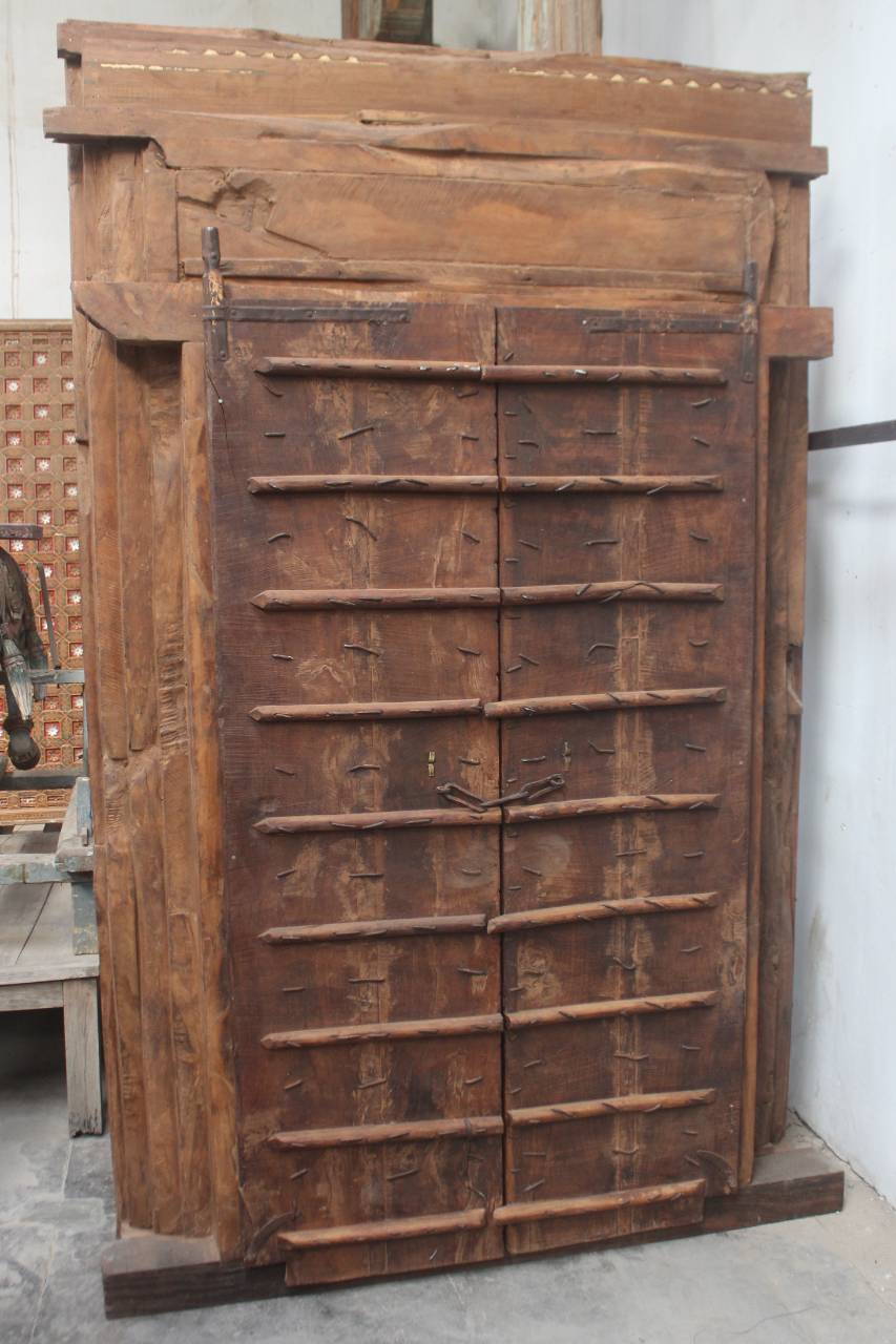 Vintage wooden printing press with intricate design on a concrete floor.