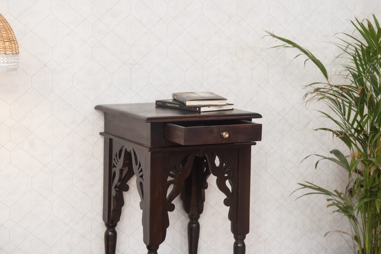 Enhance your home decor with the Heritage Sheesham Side Table, a beautifully handcrafted wooden table featuring intricate carvings and a rich, dark finish. 