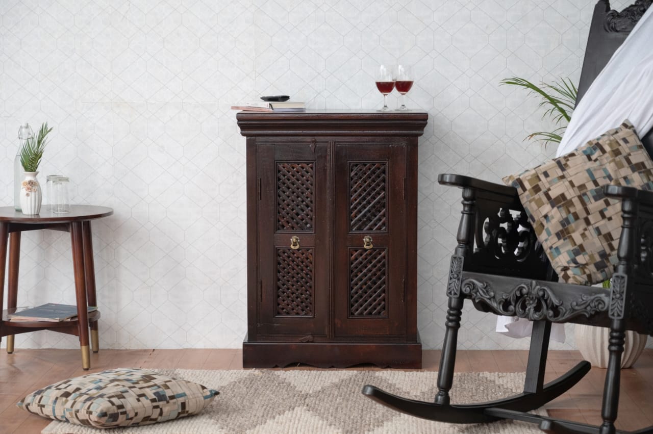 Designed with intricate latticework panels and a rich, dark finish, this vintage-inspired piece adds a touch of regal elegance to any room.
