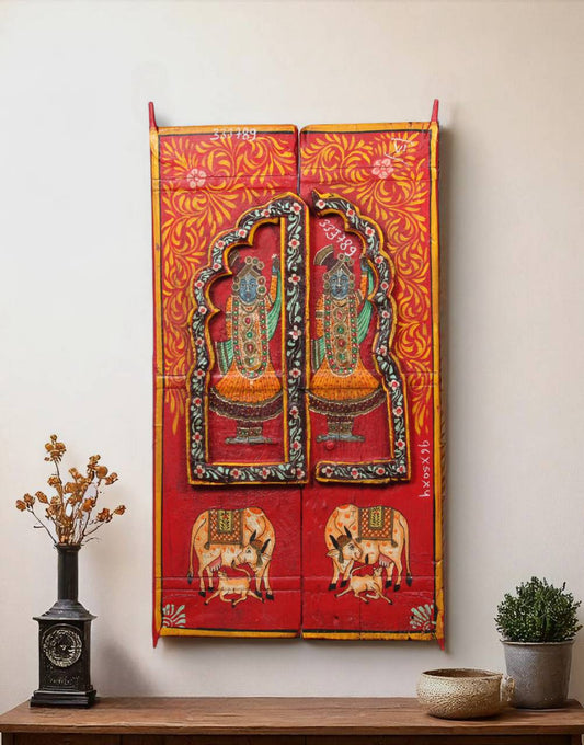 Adorned with vibrant hand-painted depictions of Lord Krishna and sacred cows, this wall panel brings spiritual warmth and traditional artistry into your home.